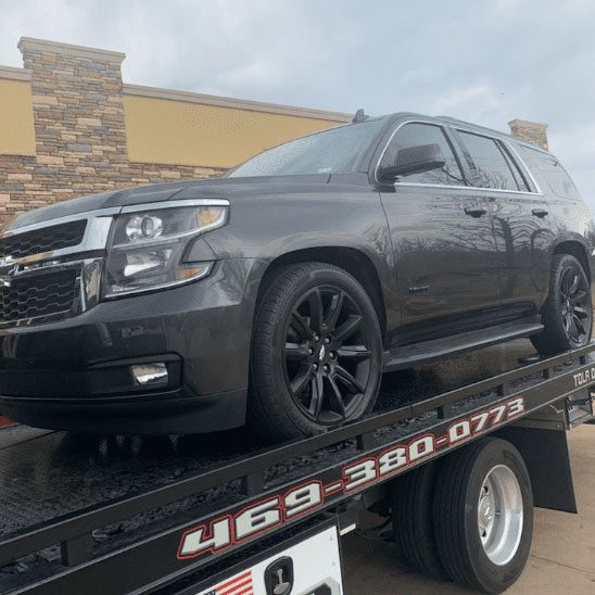 Flatbed Towing Black Chevrolet Car