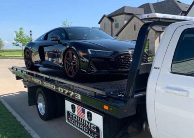 Flatbed Towing Black Sports Car