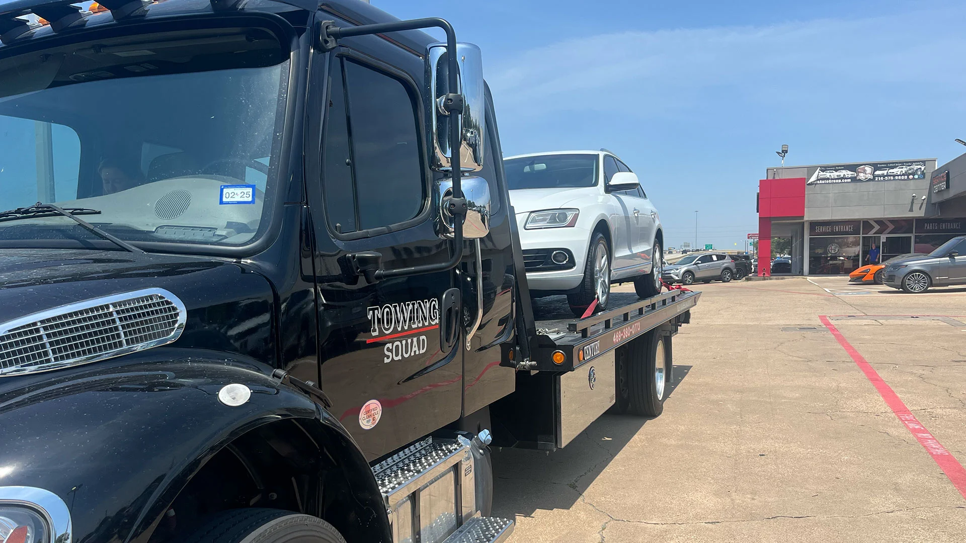 Towing Squad flatbed tow truck carrying a white SUV in Allen, TX