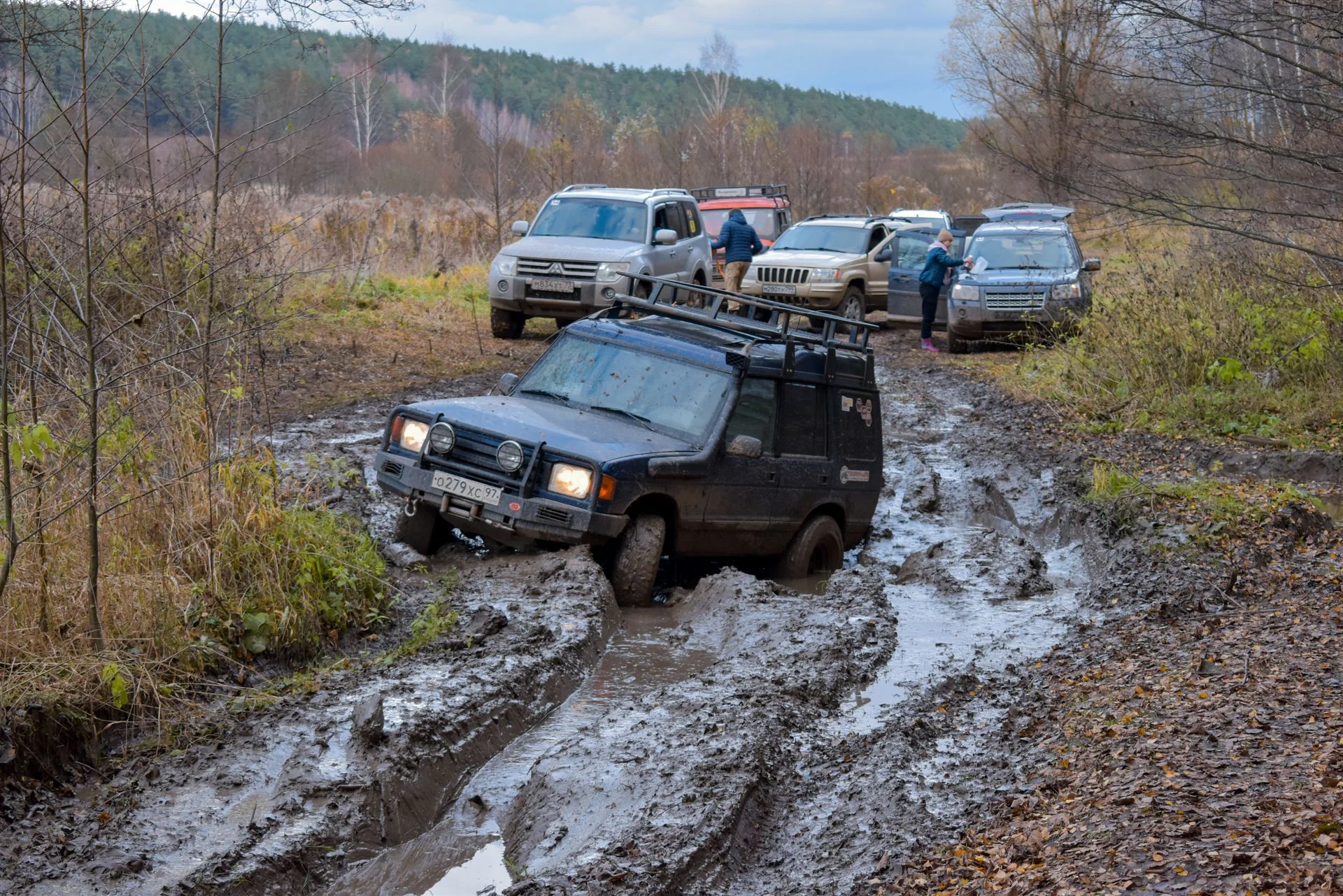 Vehicles stuck on a muddy road waiting for a winch out