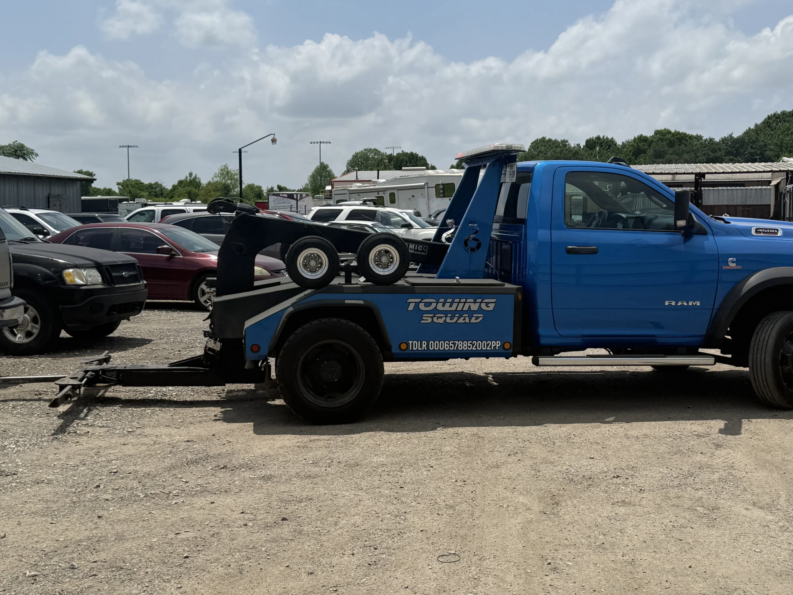 Side view of the blue Towing Squad Ram wheel-lift wrecker